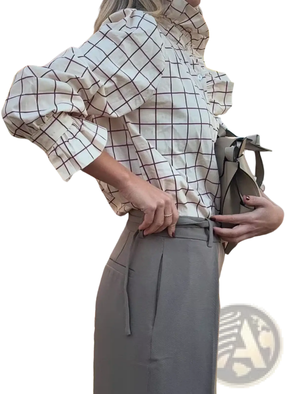 A woman wears a white chiffon checkered blouse with ruffled sleeves paired with high-waisted gray trousers