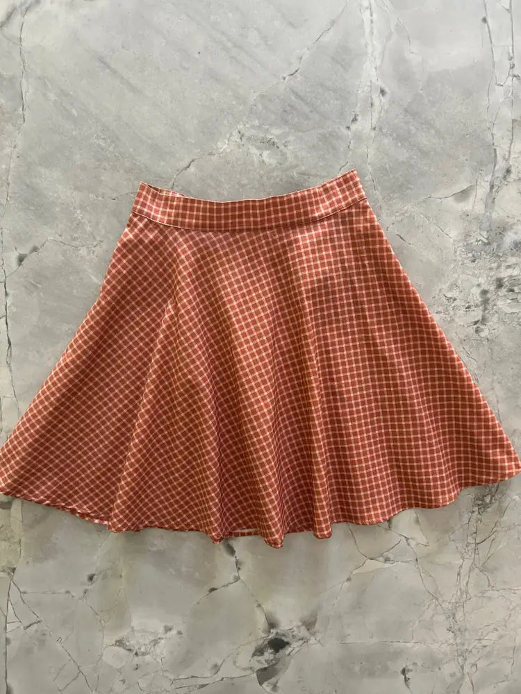 Red and white checkered cotton skater skirt with flared design made of lightweight fabric