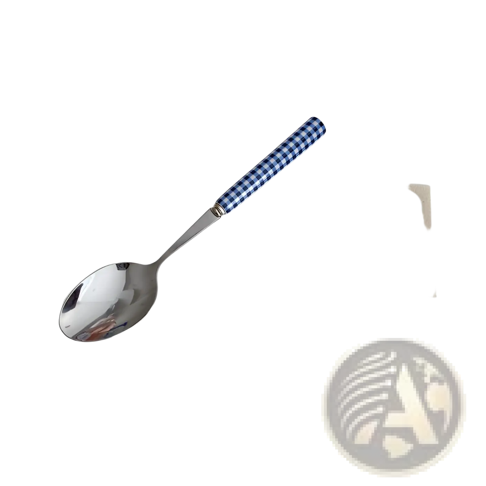 A sleek stainless steel spoon with a blue and white checkered handle from a checkered stainless steel cutlery set
