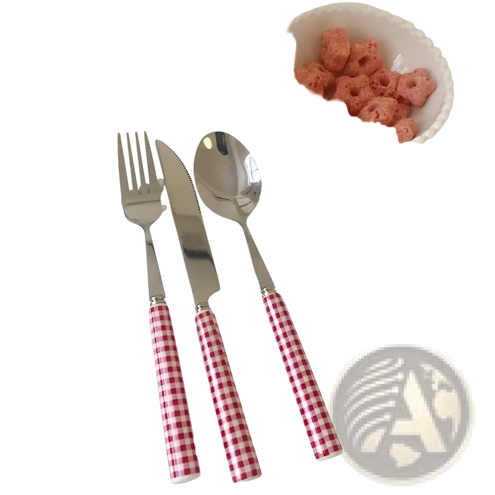Set of three stainless steel cutlery pieces with red and white gingham handles on a scalloped white plate