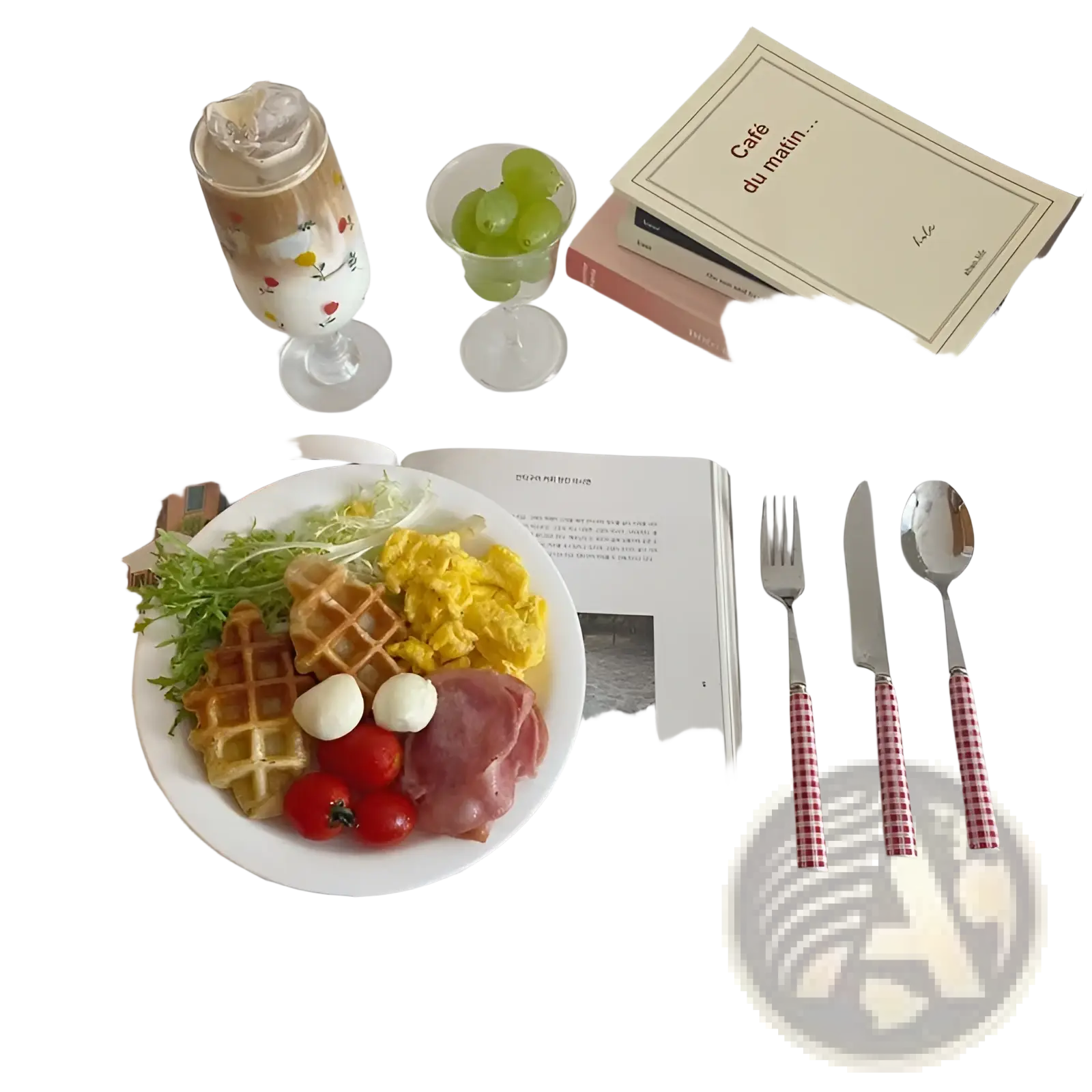 White plate with waffle scrambled eggs ham tomatoes and mozzarella balls alongside checkered stainless steel cutlery set
