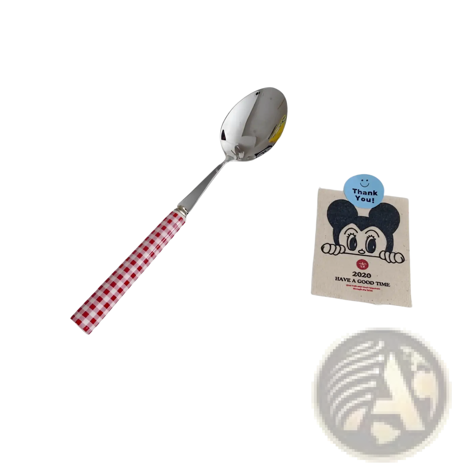 A shiny stainless steel spoon with a red and white checkered handle from the checkered stainless steel cutlery set