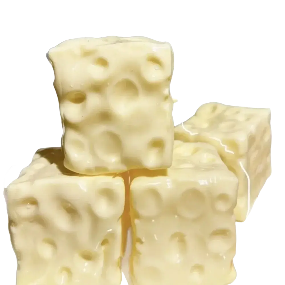 Cream-colored cube-shaped cheese block stress relief squeeze toy with textured surface mimicking swiss cheese holes