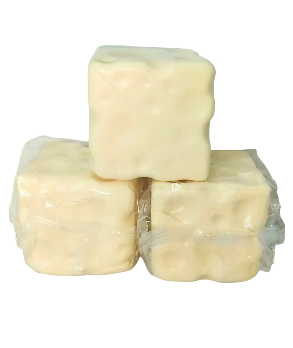 Three pale yellow cube stress balls shaped like cheese cubes with textured surfaces individually wrapped in clear plastic