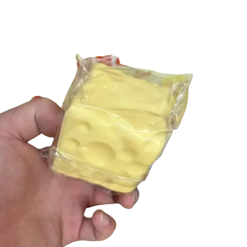 Yellow cheese-shaped fidget toy 6cm x 6cm in clear plastic wrapper for stress relief and sensory play