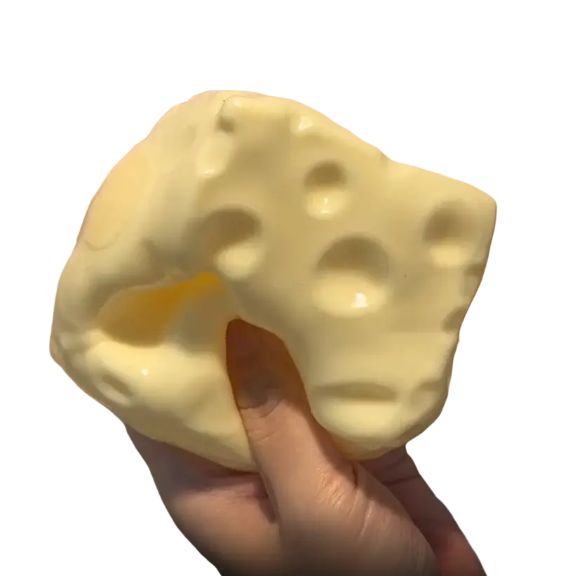 A pale yellow cheese-shaped fidget toy with glossy finish and holes designed for toy stress relief and stress relief