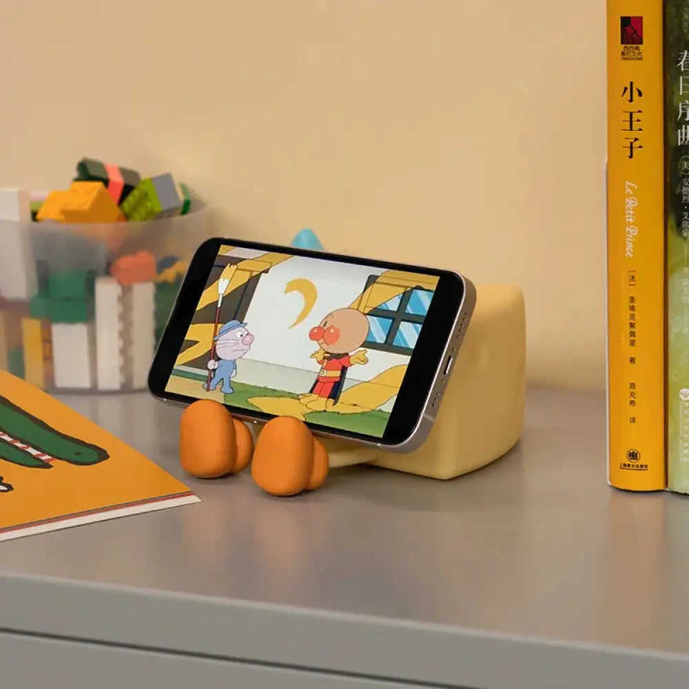 Yellow ceramic phone stand shaped like a cartoon character with orange feet for cute cheese silicone led night light for kids