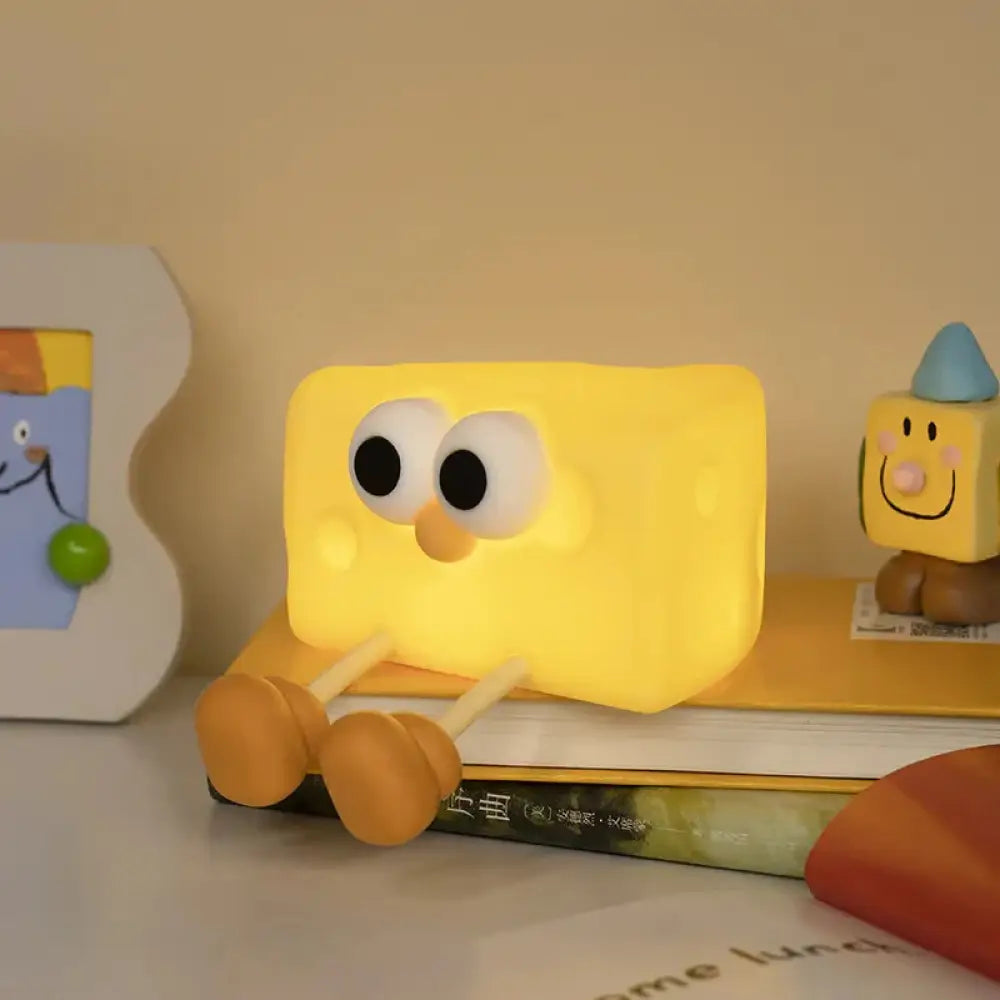 Yellow rectangular spongebob squarepants-shaped silicone led night light with large black eyes and orange nose for kids