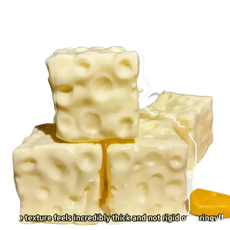 Cream-colored cube-shaped cheese squishy stress relief fidget toy with textured surface mimicking swiss cheese holes