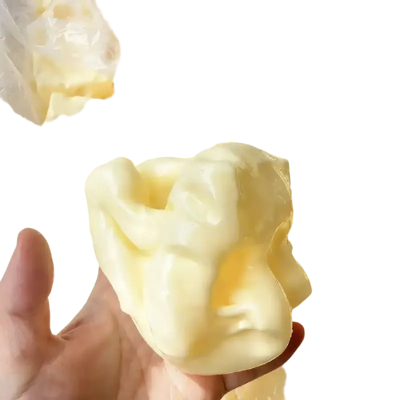 A creamy yellow cheese squishy stress relief fidget toy with a glossy finish and realistic holes