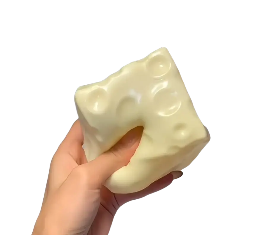 Cream-colored cheese squishy toy with glossy finish and characteristic holes slow rising sensory stress relief squishy toy
