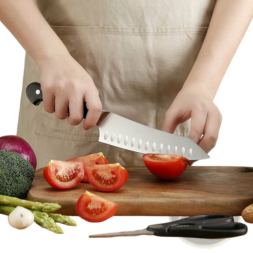 A sleek stainless steel chef knife with black handle and oval indentations in chef knife set with kitchen shears