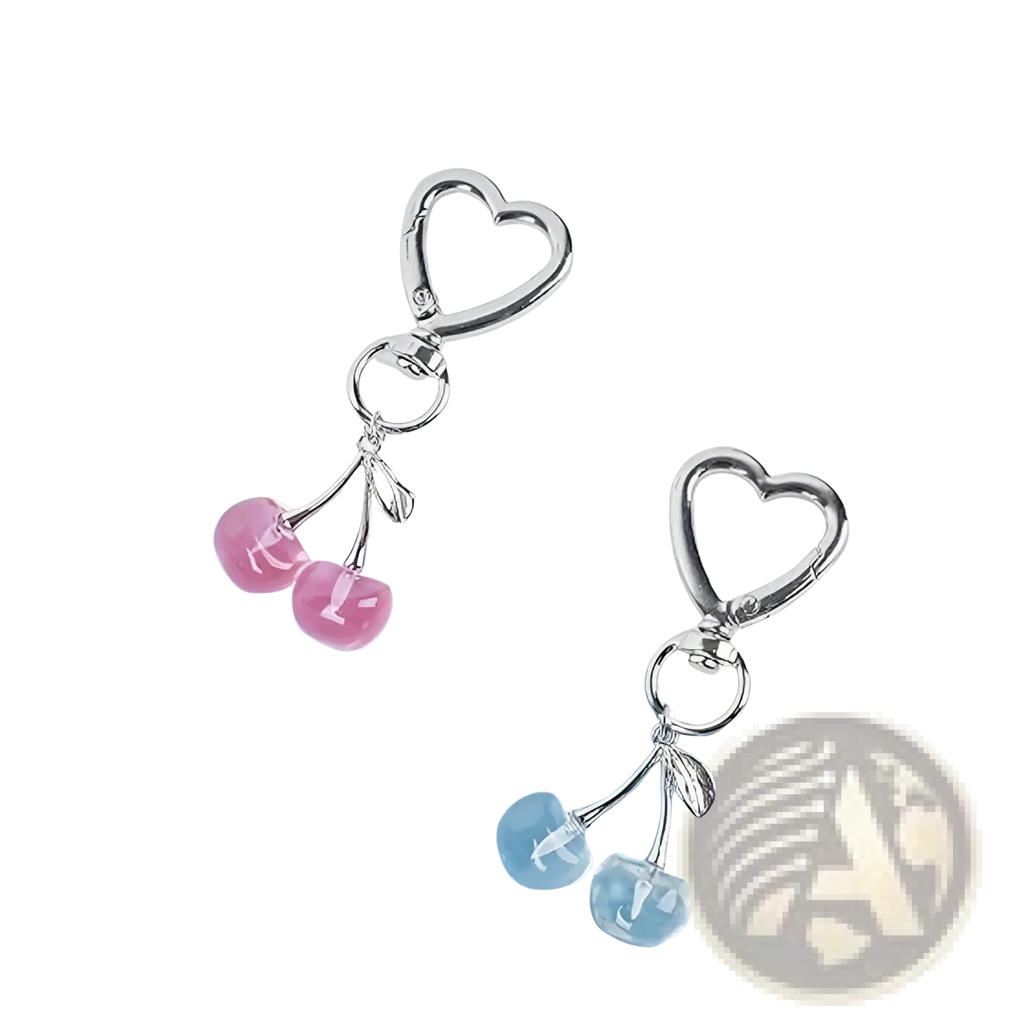 Silver heart-shaped keychain with dangling pink and blue cherry charms designed as a stylish bag charm accessory