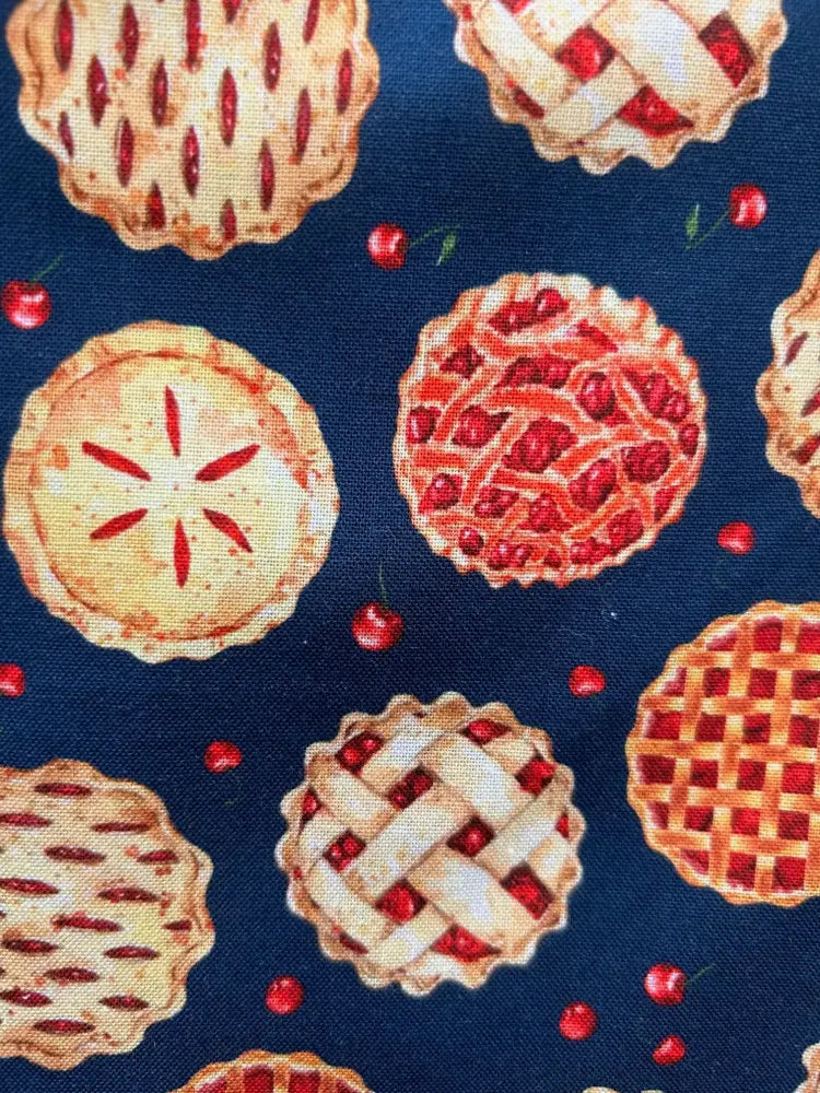 Blue fabric of cherry pie print retro fit and flare mini dress with repeating illustrated pies and red cherries pattern