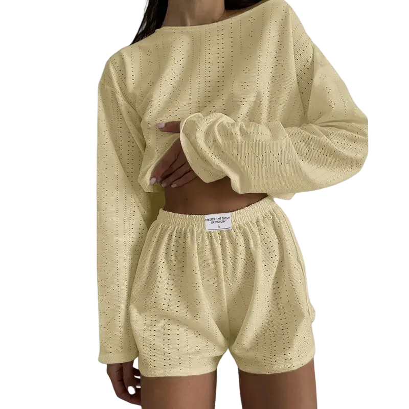A soft pale yellow eyelet knit chic pajama set with a cropped long sleeve top and breathable high split shorts