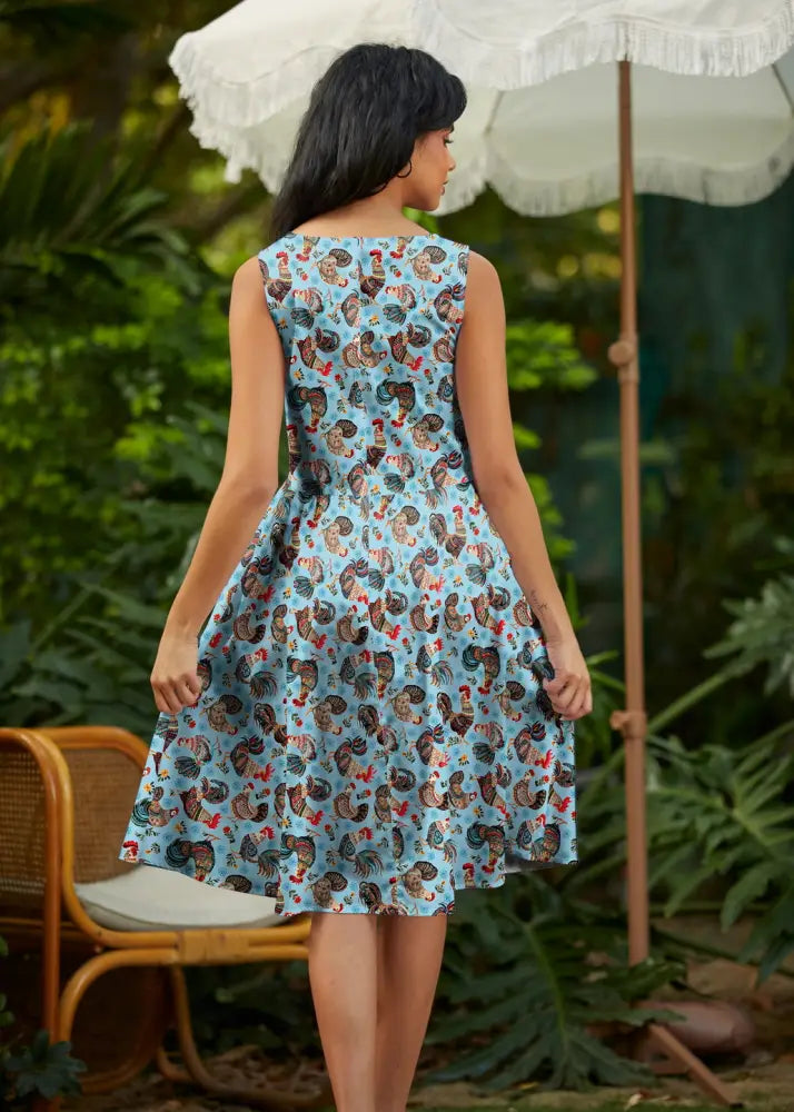 Sleeveless light blue cotton 1950s a-line dress with brown and red rooster print and pockets on soft fabric