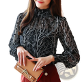 Tan leather clutch with gold-tone hardware and chain strap shown with chiffon floral print long sleeve blouse