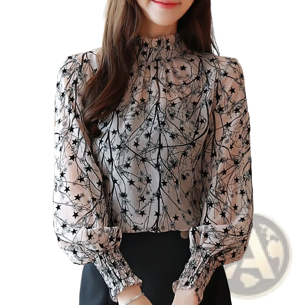 A sheer light beige chiffon floral print long sleeve blouse with black star and branch pattern and elastic cuffs