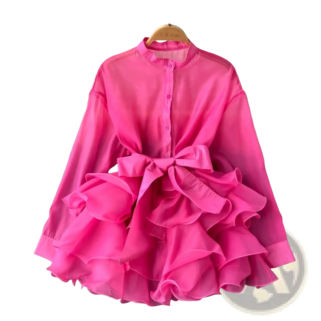 A vibrant fuchsia chiffon ruffle blouse long sleeve top with high collar front buttons and waist bow detail