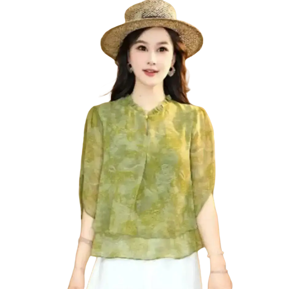 A woman wears a light green chiffon ruffle short sleeve blouse with floral pattern highlighting size shoulder chest