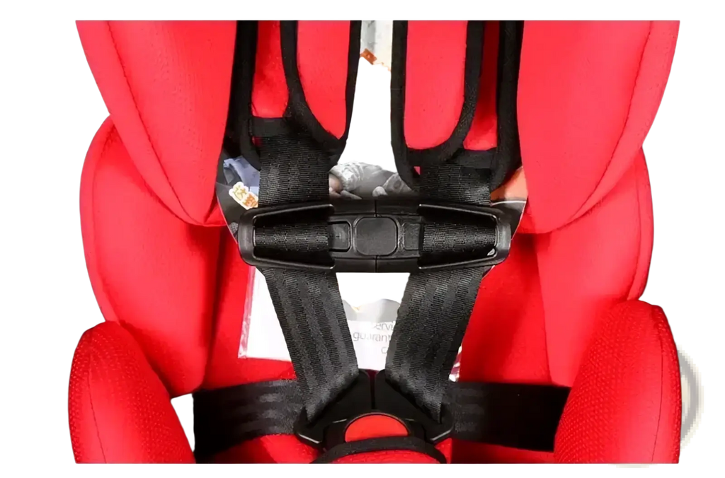 Red child safety seat strap clip with black harness straps and buckle securely attached to a car seat