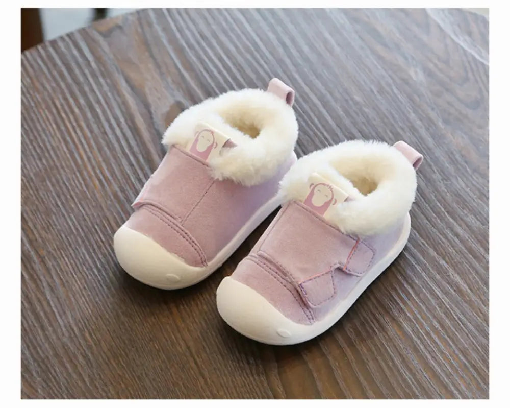Pink toddler snow boots with fluffy white faux fur lining soft suede upper and animal cartoon face patches on the side