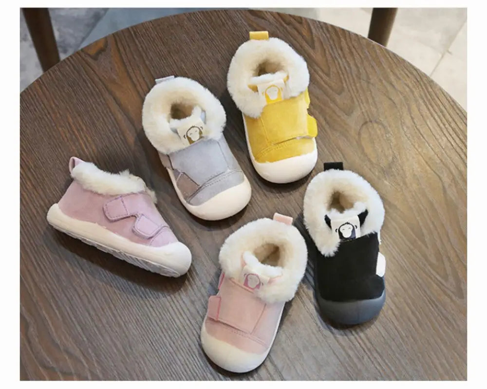 Animal themed plush faux fur toddler snow boots in pastel pink gray yellow and black with velcro straps and animal faces