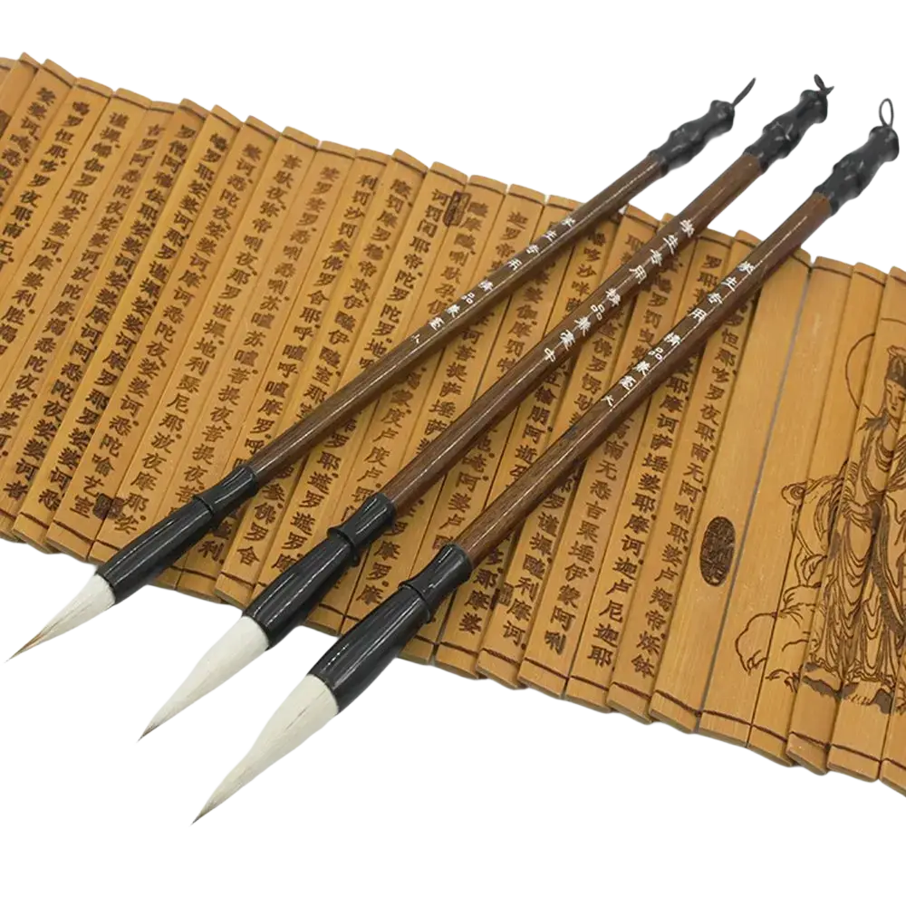 Three traditional chinese calligraphy brushes with dark brown wooden handles and white animal hair tips on bamboo scrolls