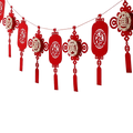 Red paper lantern garland with intricate cut-out chinese characters and tassels for chinese new year decor