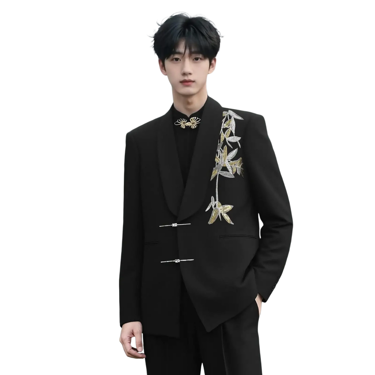 Black tailored suit jacket with intricate gold and silver leaf embroidery on lapel and front closure for groom wedding