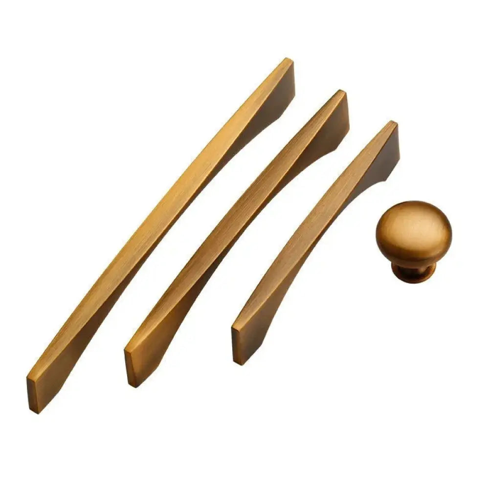 Set of three minimalist brushed brass cabinet pulls with tapered ends and one matching round knob for cabinets