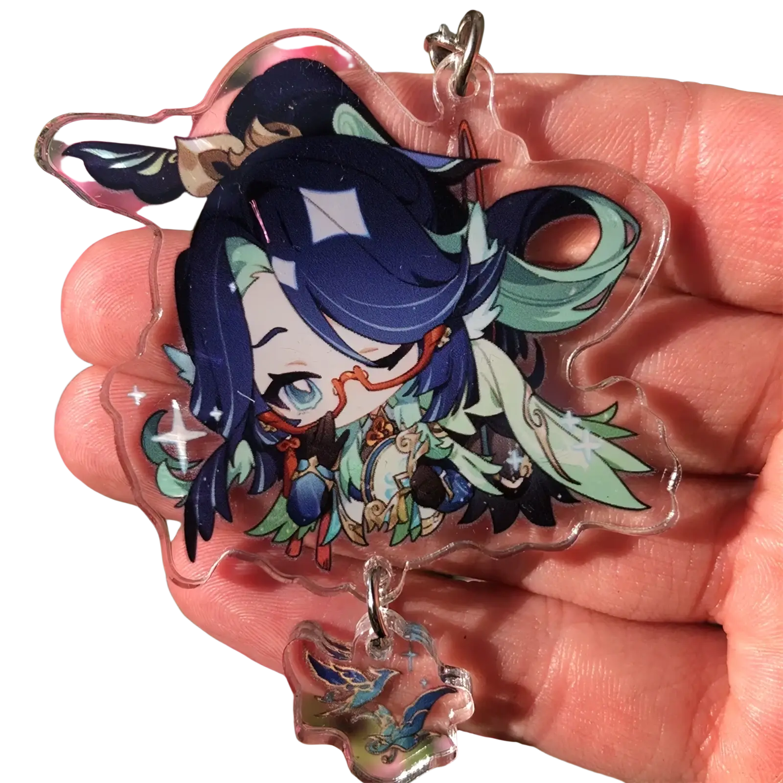 Clear acrylic chiori keychain featuring a chibi character with deep blue hair teal accents and sparkling star details