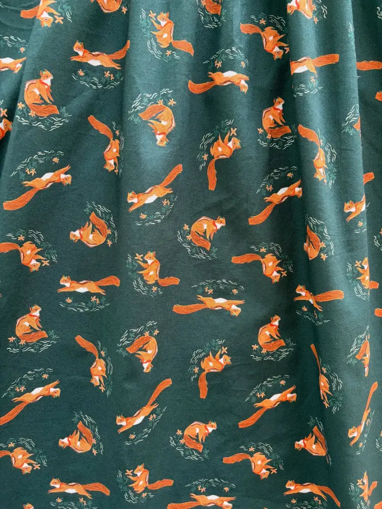 Dark green chipmunks vintage fit and flare cotton dress with pockets featuring orange squirrel and leafy wreath pattern