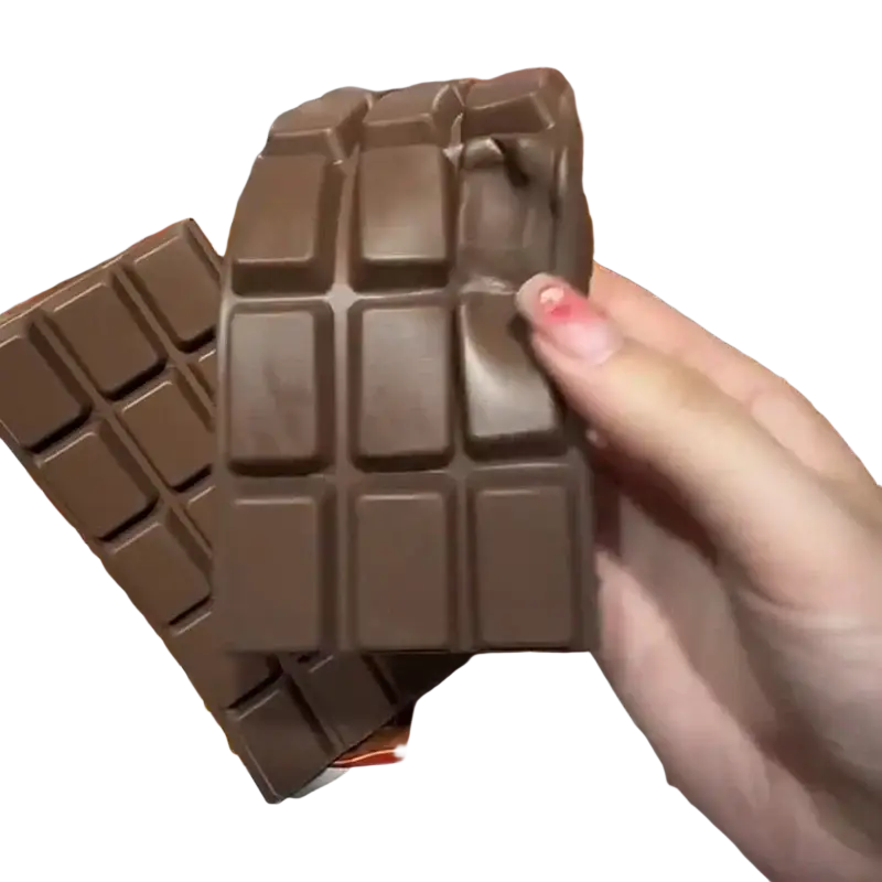 A glossy dark brown chocolate bar squeeze toy with classic segmented grid design slow rising sensory fidget