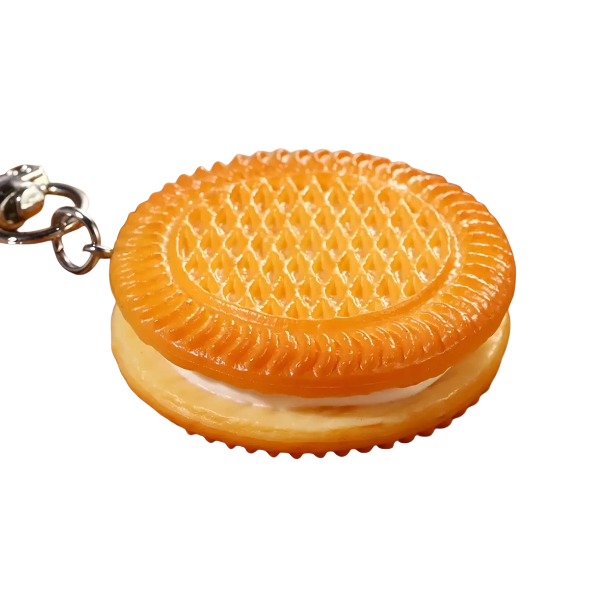 Orange plastic keychain shaped like a miniature sandwich cookie with detailed grid patterns for bag pendant use
