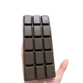 A dark brown chocolate squeeze toy with a smooth glossy surface and segmented design for stress relief