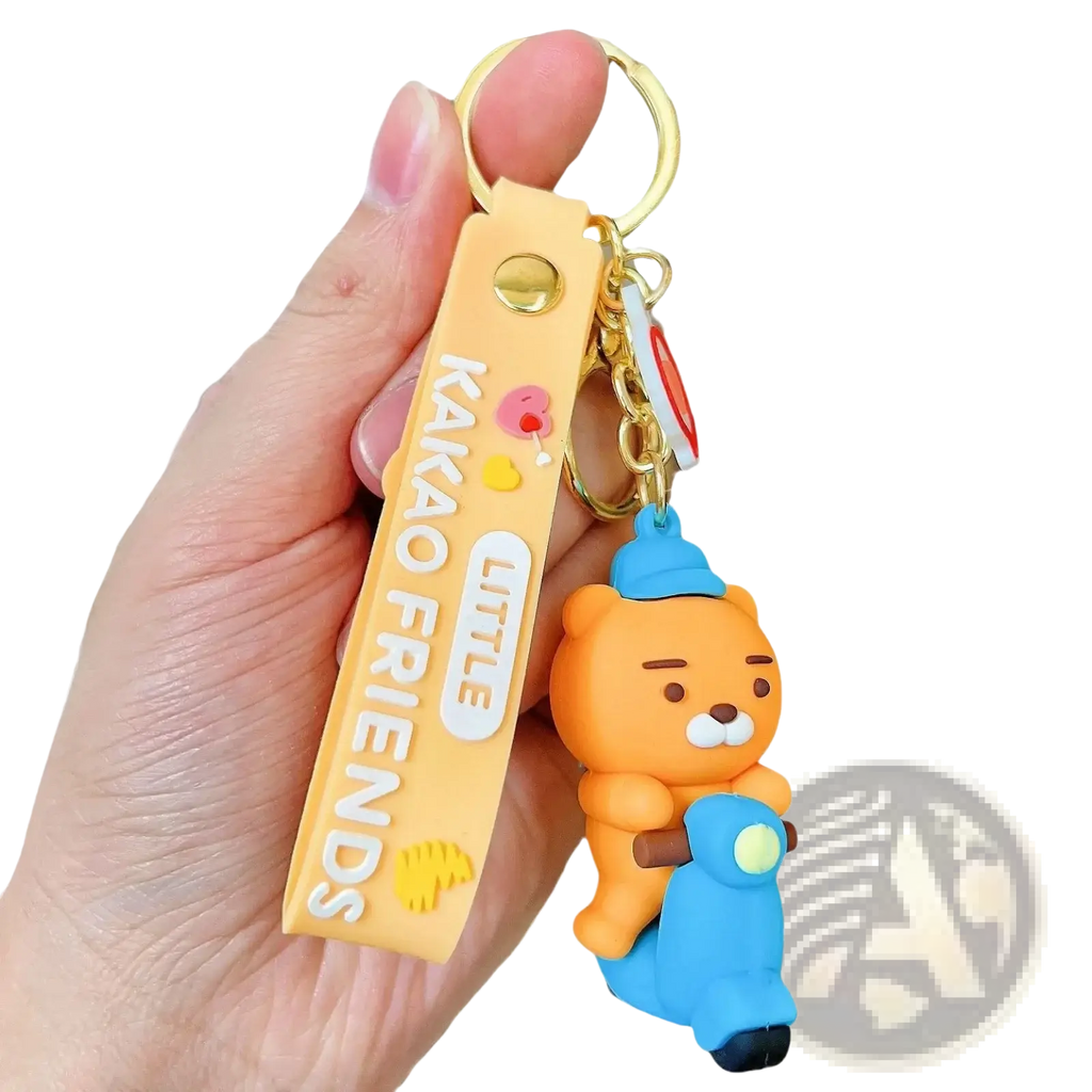 Orange silicone bear figurine keychain with blue scooter and yellow strap featuring little friends branding vintage style