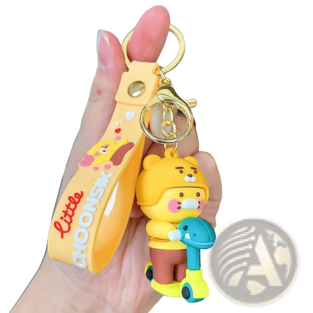 Yellow silicone choonsik scooter keychain featuring a cartoon bear holding a scooter with little choonsk lettering
