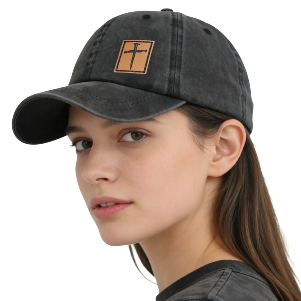 Black distressed baseball cap with tan leather patch featuring black stitched Christian cross in the center