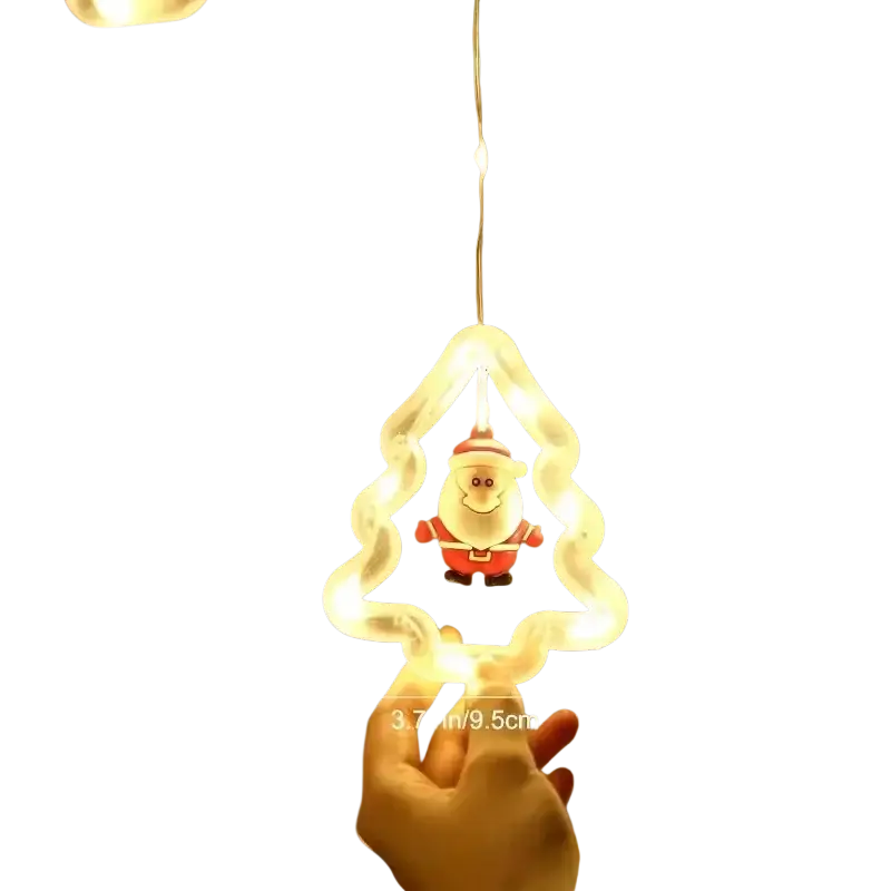A glowing white christmas tree-shaped light ornament with a red and white santa inside from christmas curtain string lights