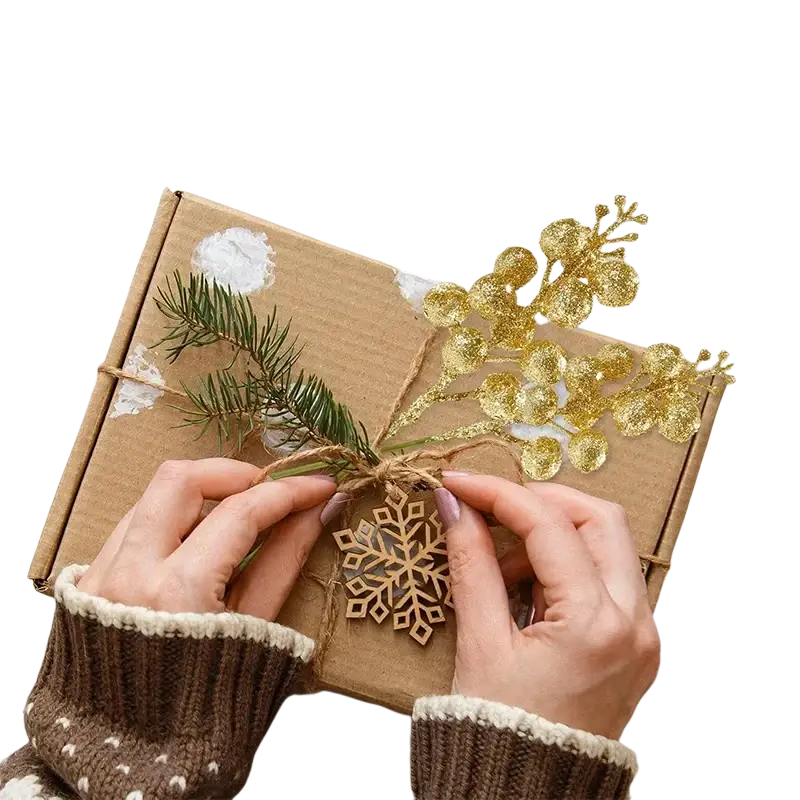 A rustic brown cardboard flower bouquet with pine branches and christmas decoration glitter eucalyptus sprigs