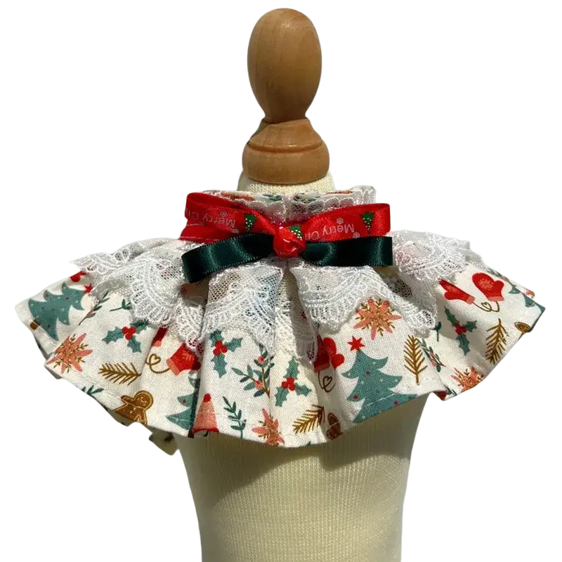 Christmas dog collar with white lace trim red and green bow and festive fabric featuring trees holly and gingerbread men