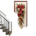 Christmas door wreath with bells and red bow featuring festive red and gold garland with pine branches and berries