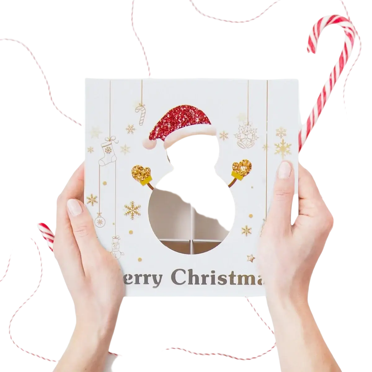 White christmas-themed paper gift box with clear six-compartment window, glittery red santa hat, and gold snowflake decorations for cookies