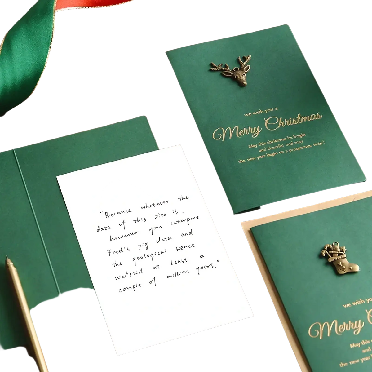 Emerald green christmas greeting card with gold foil lettering and a bronze deer embellishment included in card set