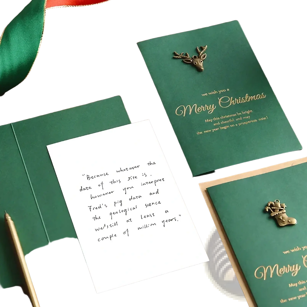 Emerald green christmas greeting card with gold foil lettering and a bronze deer embellishment included in card set