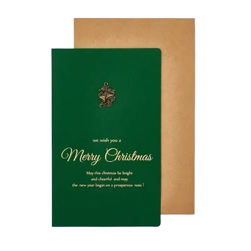 Green christmas greeting card with gold foil lettering and metallic bell emblem paired with matching brown envelope