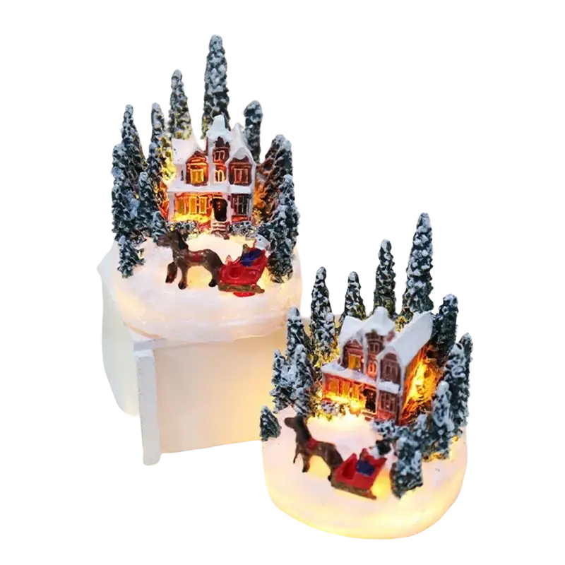 Two miniature christmas house night light figurines with glowing windows snow decorations and reindeer sleigh detail