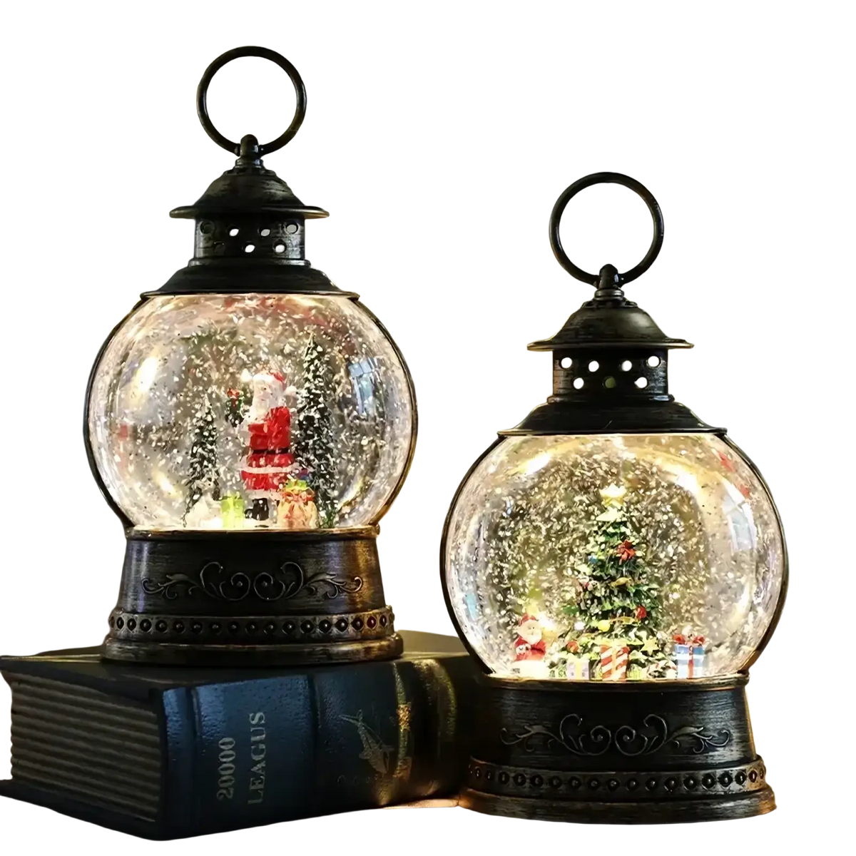 Two ornate black lantern snow globe music boxes featuring glowing miniature christmas scenes and falling glitter