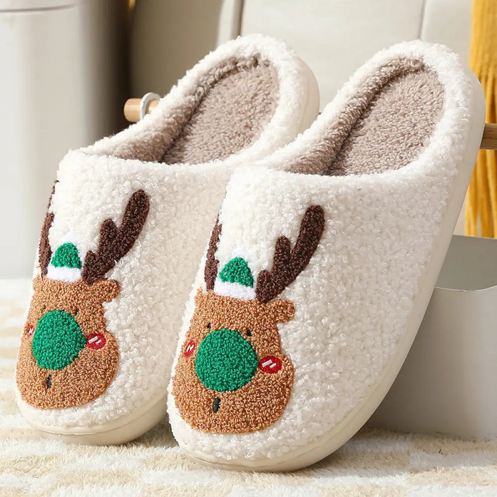 White plush reindeer plush christmas slippers with cozy faux fur featuring embroidered faces with green hats and brown antlers